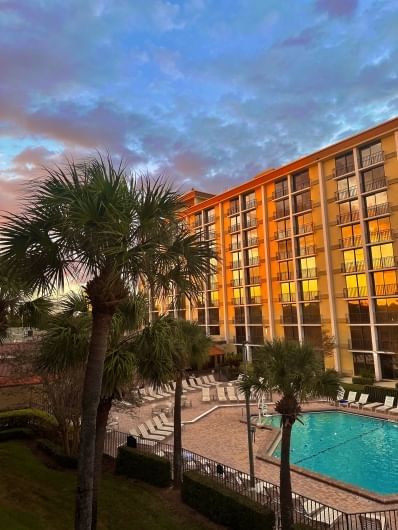 The exterior of Rosen Inn closest to Universal and its pool at sunrise.  