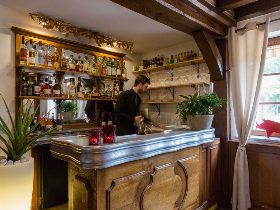 A bartender wipes the bar counter at L'oree des chences