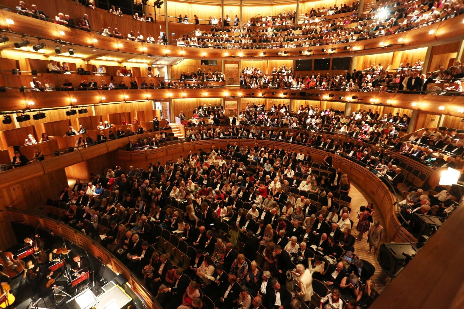 Glyndebourne Festival audience, seated inside a packed multi-level auditorium