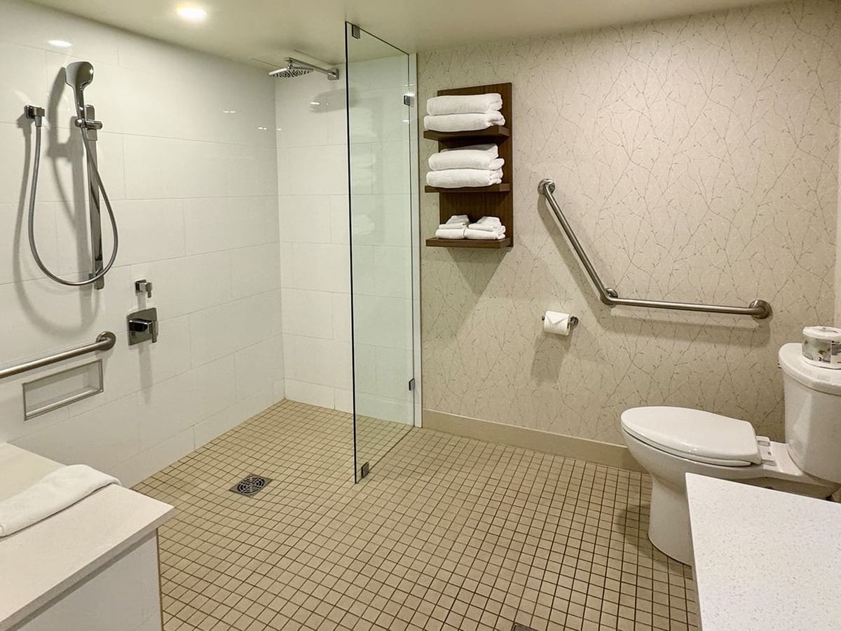 Accessible washroom with a roll-in shower, toilet and towels