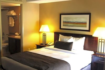 Painting hung by the bed in Studio One Queen Bed at Franklin Suite Hotel, Fort Mcmurray Hotels