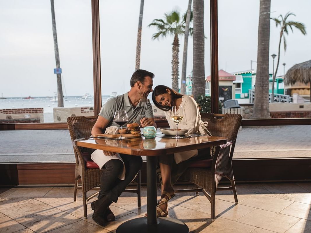 Couple posing and enjoying their meal in Avalon Grille, Avalon restaurants at Hotel Atwater
