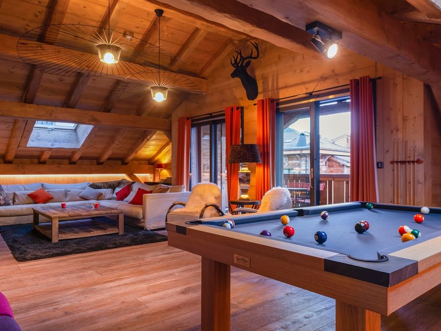 Gaming area with a pool table & lounge space at Chalet hotel.