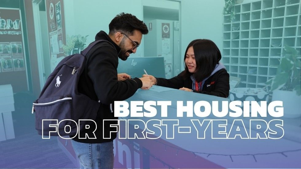 Man with backpack shakes hands with woman at a desk, with 