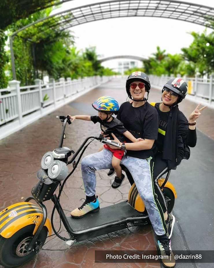 Family of 3 posing on a scooter in Lexis Hibiscus