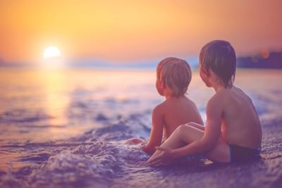 Children on beach at sunset.