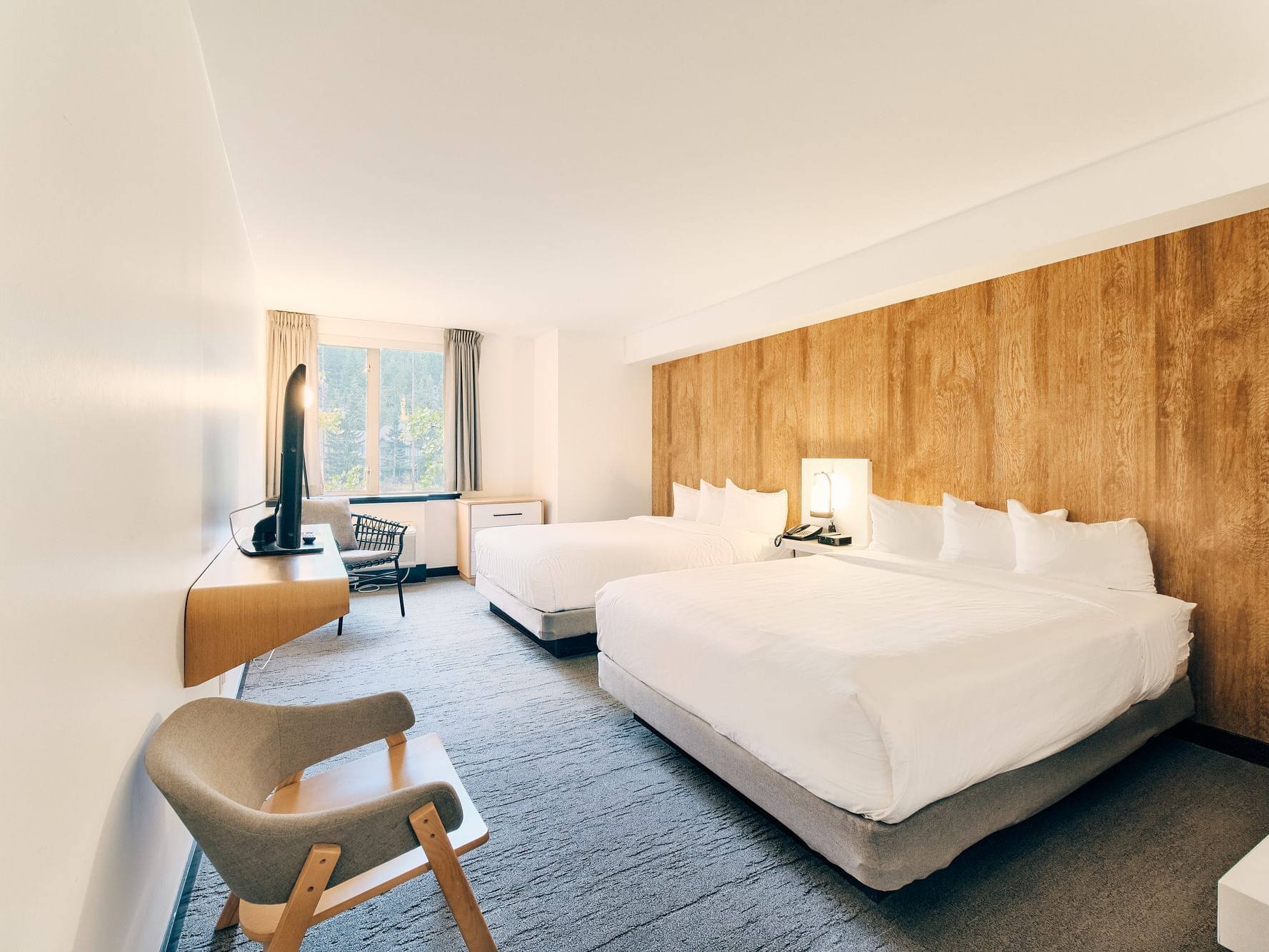 Two beds in hotel room with window