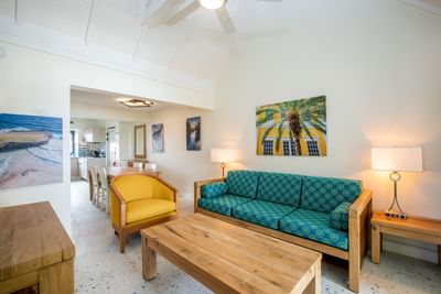 Living room with wooden furniture & decor in Two Bedroom Suite at Amsterdam Manor Beach Resort
