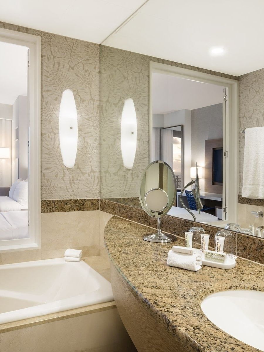 Bathroom with vanity & tub in 2 Double Beds Oceanfront View at The Diplomat Resort