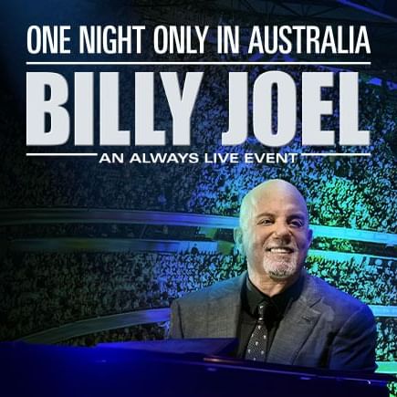 Billy Joel sitting at a keyboard