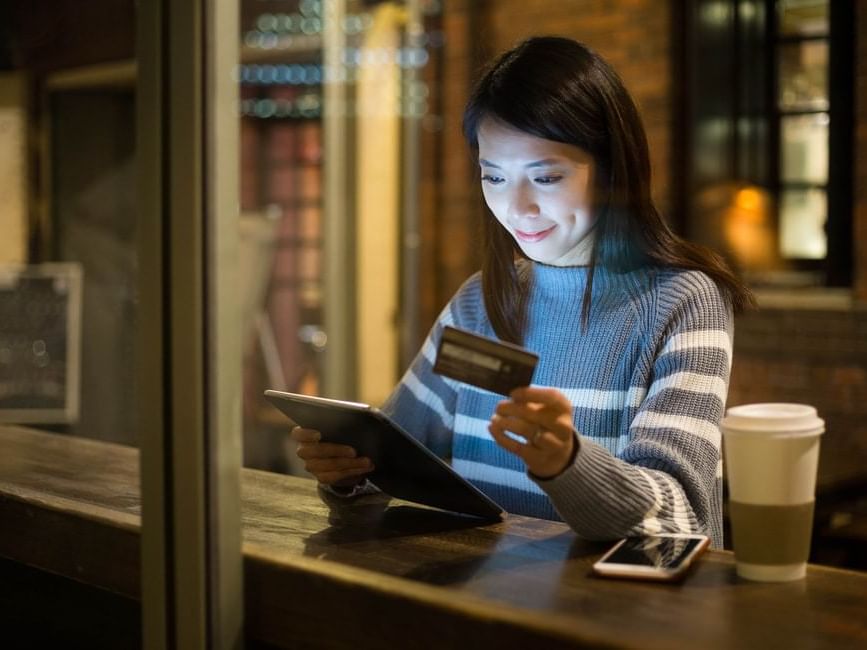 Woman making payment with credit card at Imperial Lexis 5 star Staycation in Kuala Lumpur