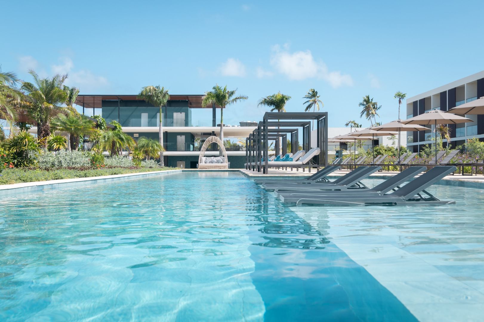 Poolside and sun beds at Live Aqua Beach Resort Punta Cana