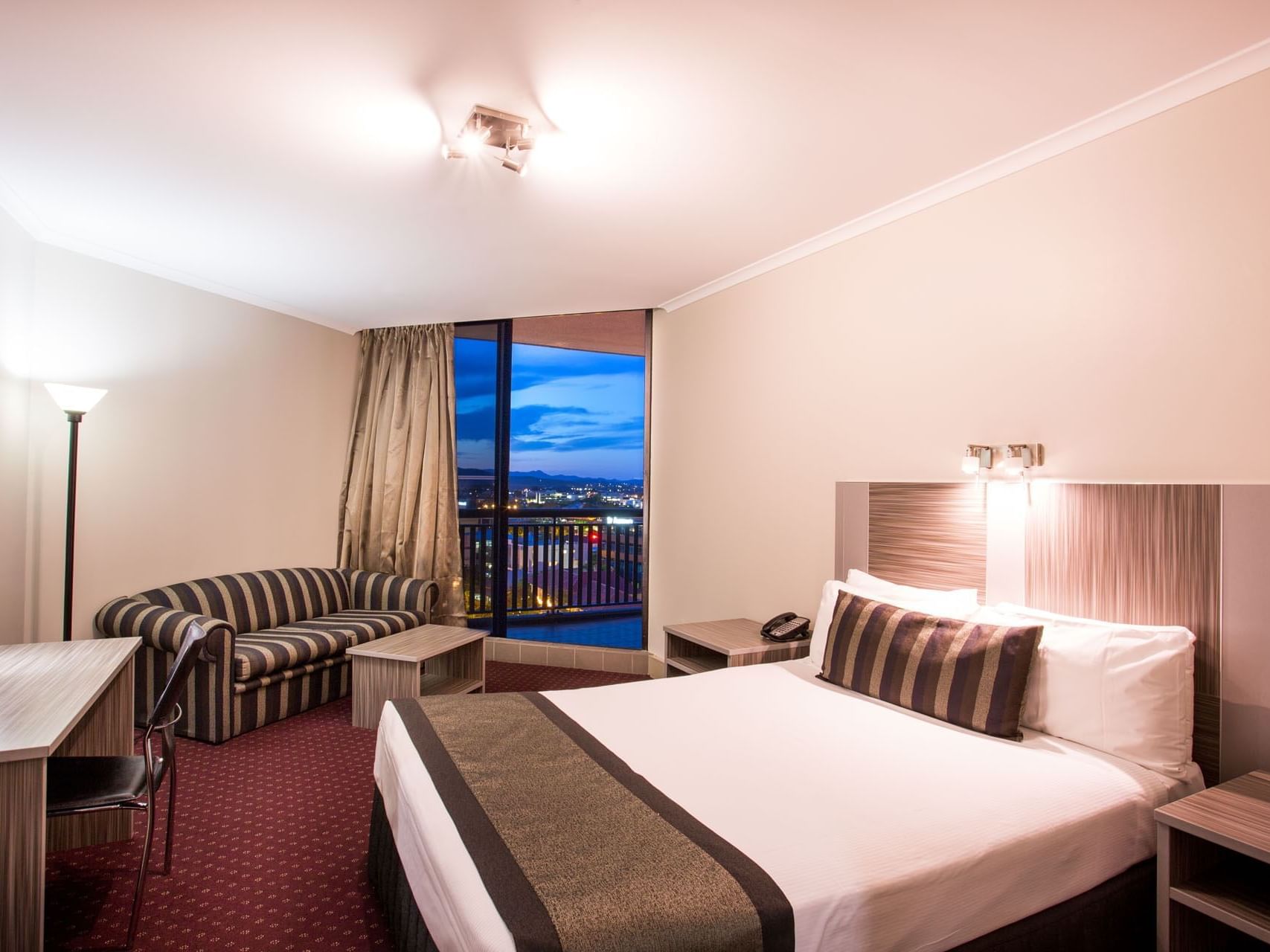 Bed and sofa in Deluxe Room at Grand Chancellor Brisbane