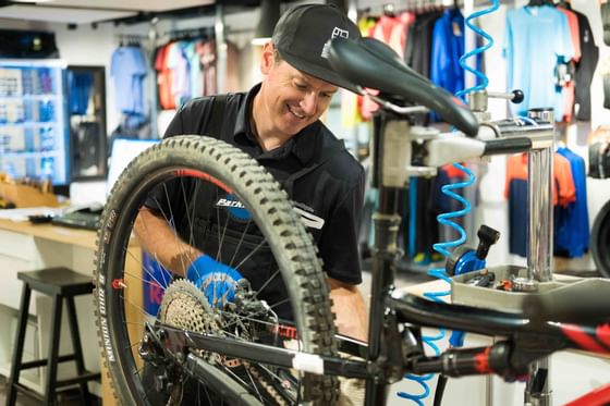 Mechanic repairing a bicycle in Stein Eriksen Sport Shop at Stein Eriksen Lodge