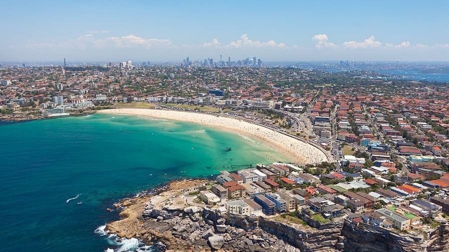 Aerial view of Maroubra Beach with golden sand, blue water, and skyline near Novotel Sydney International Airport