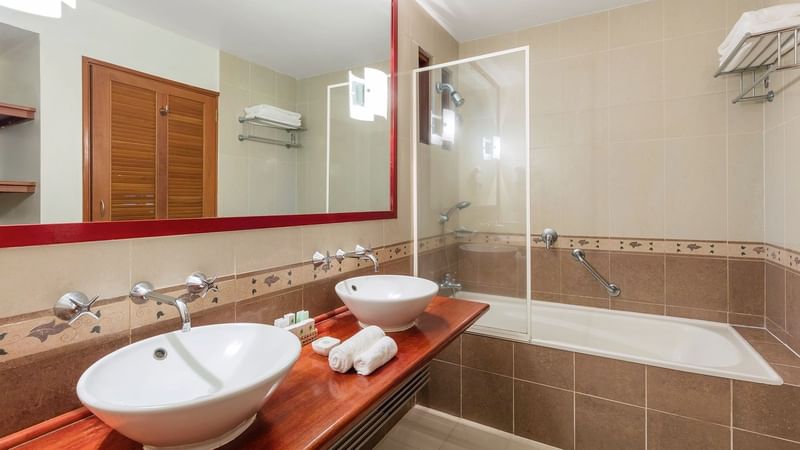 Bathroom vanity & bathtub in Family Superior Room at The Naviti Resort - Fiji