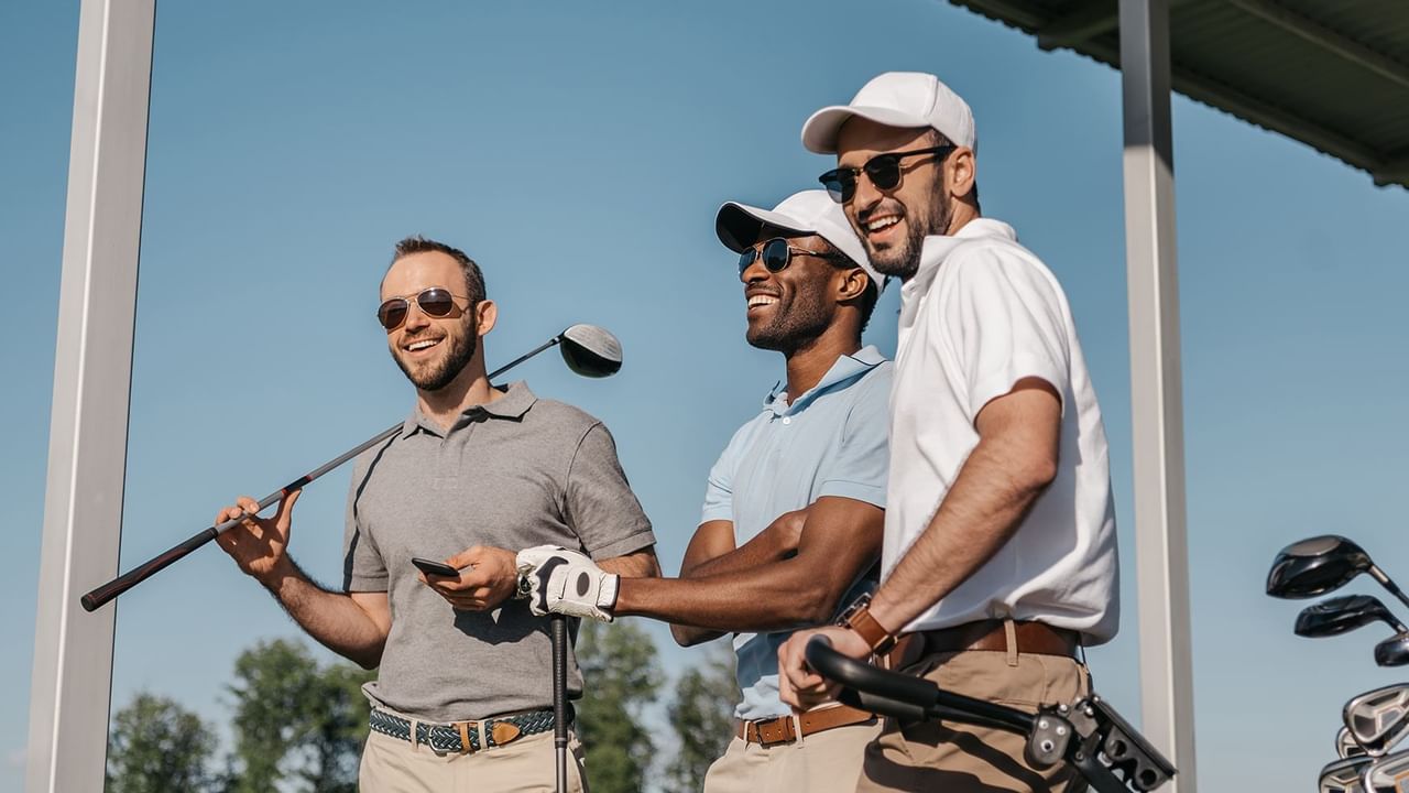 three golfers smiling