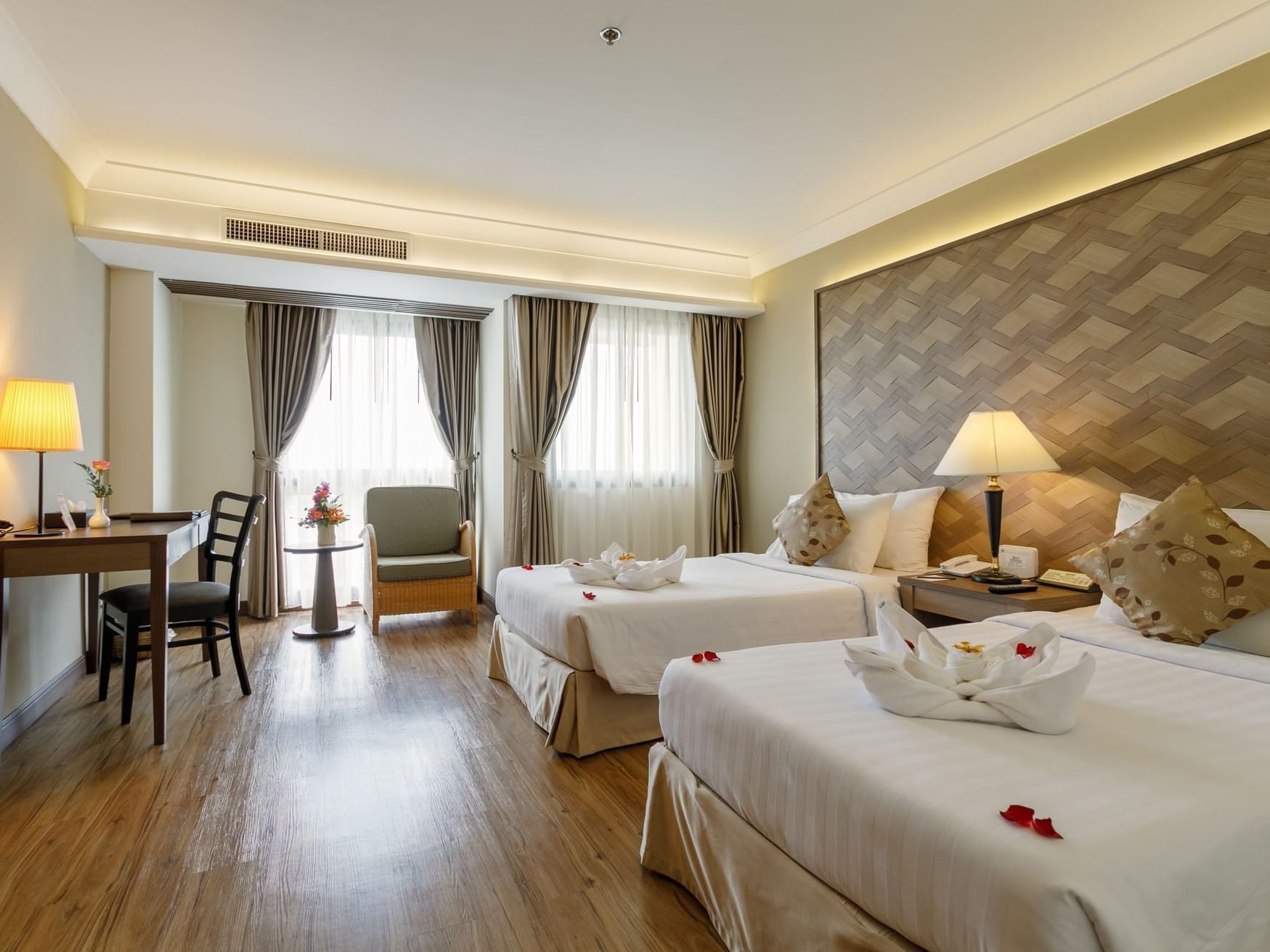 Flower petals, towels on beds in Premier Room at Amora Hotel