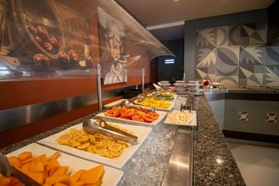 Fresh sliced fruit, including melons and limes, on a long ice bed in Fonda de San Luis at Hotel Mirra