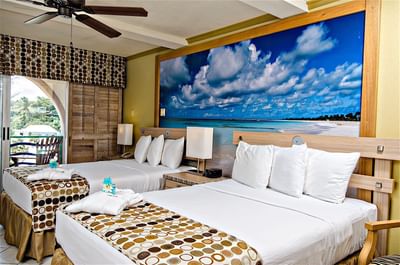 Interior of Island View Room with twin beds & a balcony at Accra Hotels & Resorts