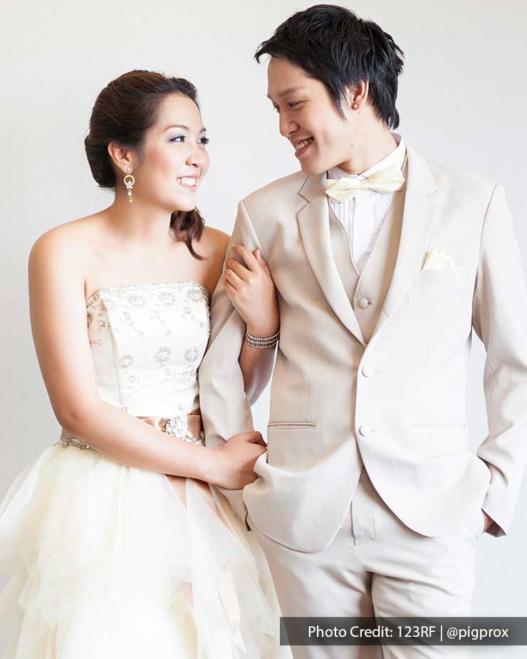 A couple wearing wedding outfits was striking a pose in front of the camera - Lexis Suites Penang