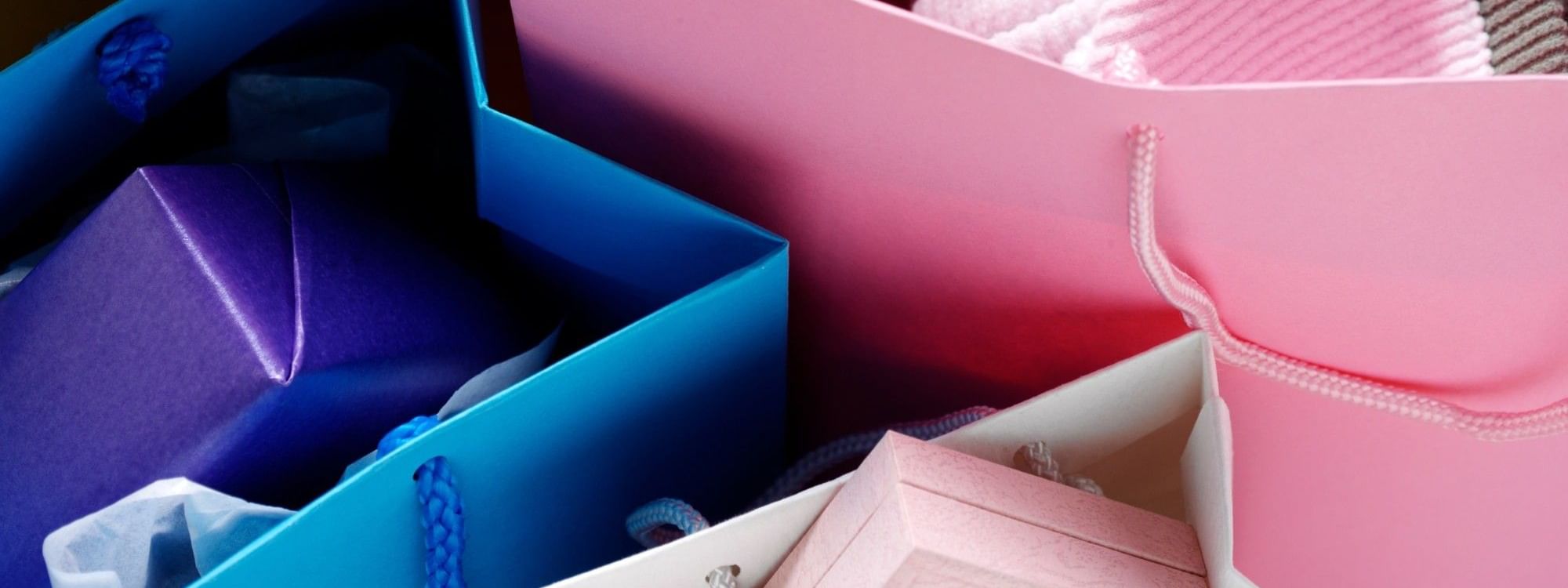 Colorful shopping bags in blue and pink with tissue paper and purchases from DFO Homebush