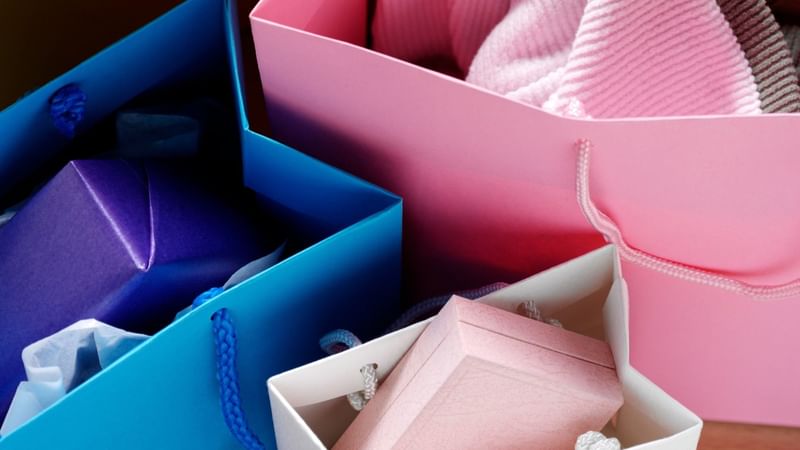 Colorful shopping bags in blue and pink with tissue paper and purchases from DFO Homebush