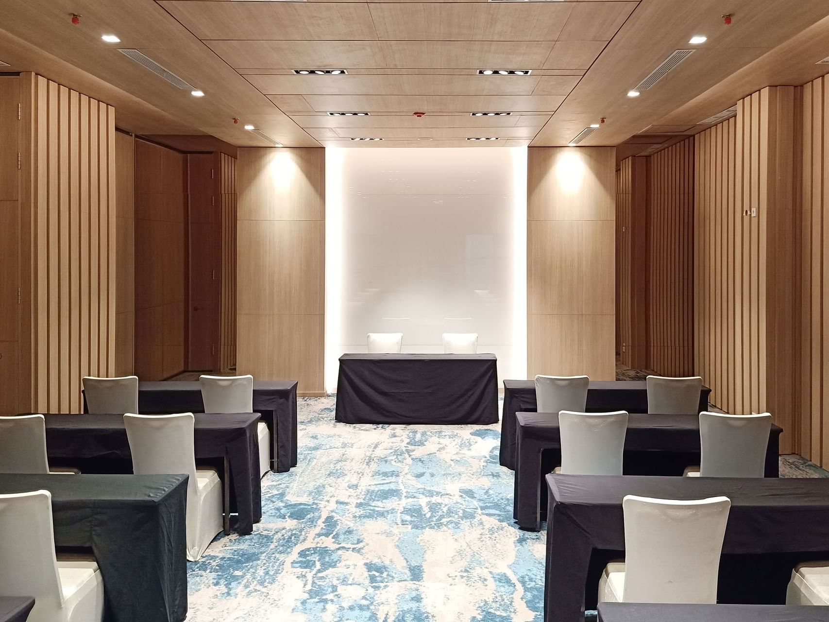 Classroom type table set up in Meeting Room 2 with carpeted floors at LK Cikarang Hotel & Residences