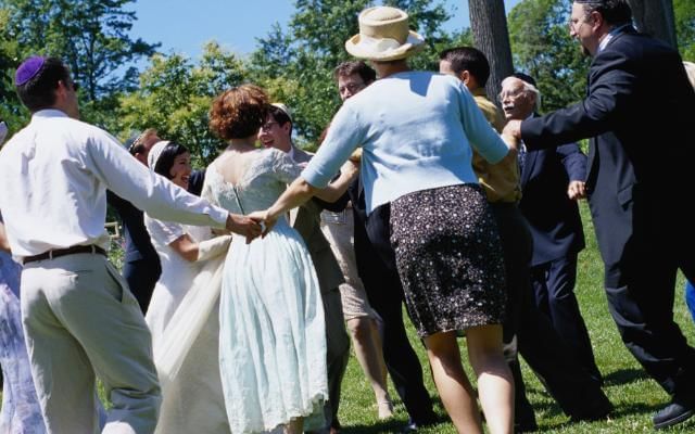 Wedding guests dancing The Hora at a traditional Jewish wedding at Gorse Hill