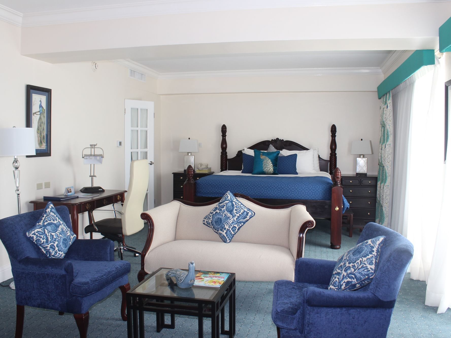 King bed & lounge area with cozy sofa in Royal Two Bedroom Suite at Jamaica Pegasus Hotel