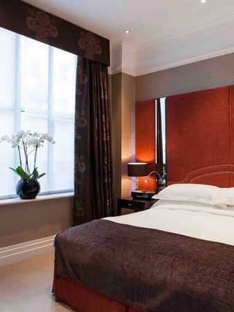 Bed between the side table near window in Classic Townhouse Room at The Capital Hotel, Apartments and Townhouse