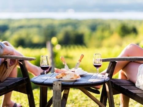 Two people drinking wine and eating bread at Travelodge Hotel & Convention Center Québec City