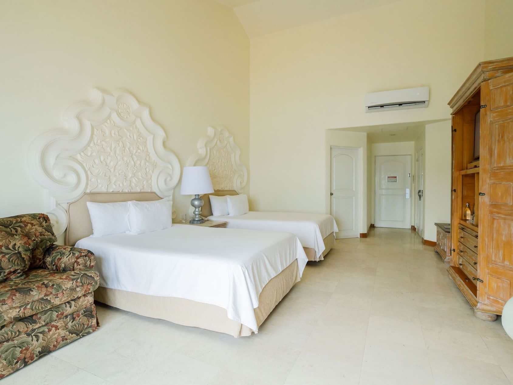 2 Double Master Suite with two beds, decorative headboards, and a wooden wardrobe at Quinta Real Acapulco