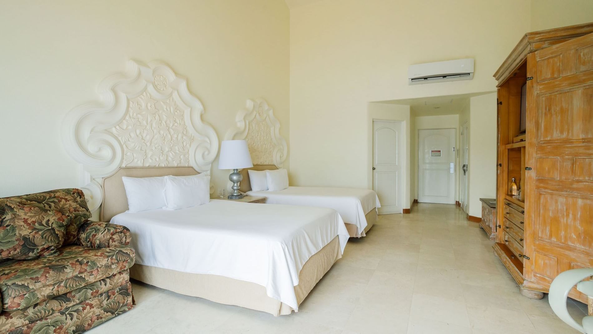 2 Double Master Suite with two beds, decorative headboards, and a wooden wardrobe at Quinta Real Acapulco