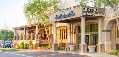 Main entrance of The Boulevard Inn & Bistro with Bistro on the Boulevard sign and parking area view