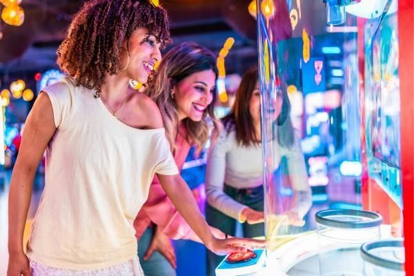 Group of women enjoying arcade games at Wokingham Superbowl.