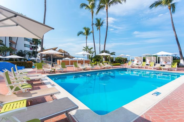 Outdoor pool with sunbeds at Buenaventura Grand Hotel and Spa