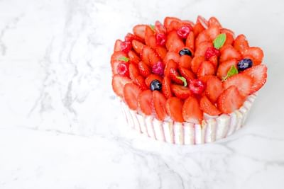 Delicious fruit tart topped with fresh berries and mint leaves in The Pastry Boutique at Park Hyatt Saigon