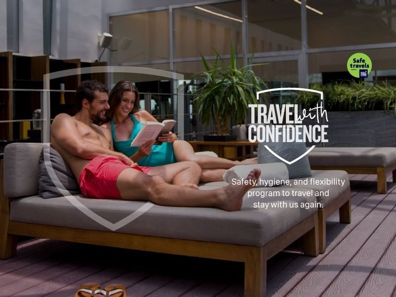 Offer poster with a couple reading a book together at FA Hotels