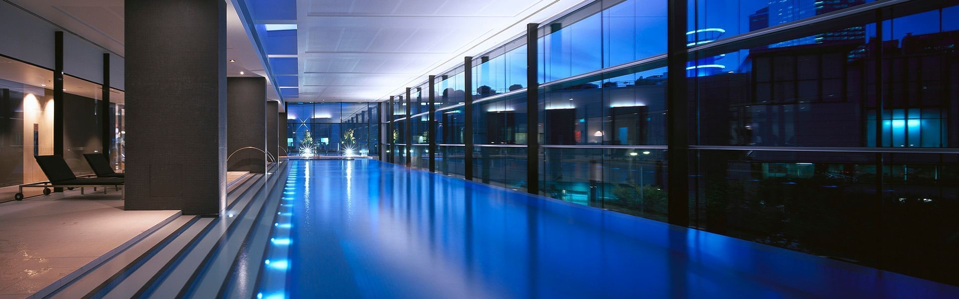 Interior of the indoor pool with city views at Crown Towers 