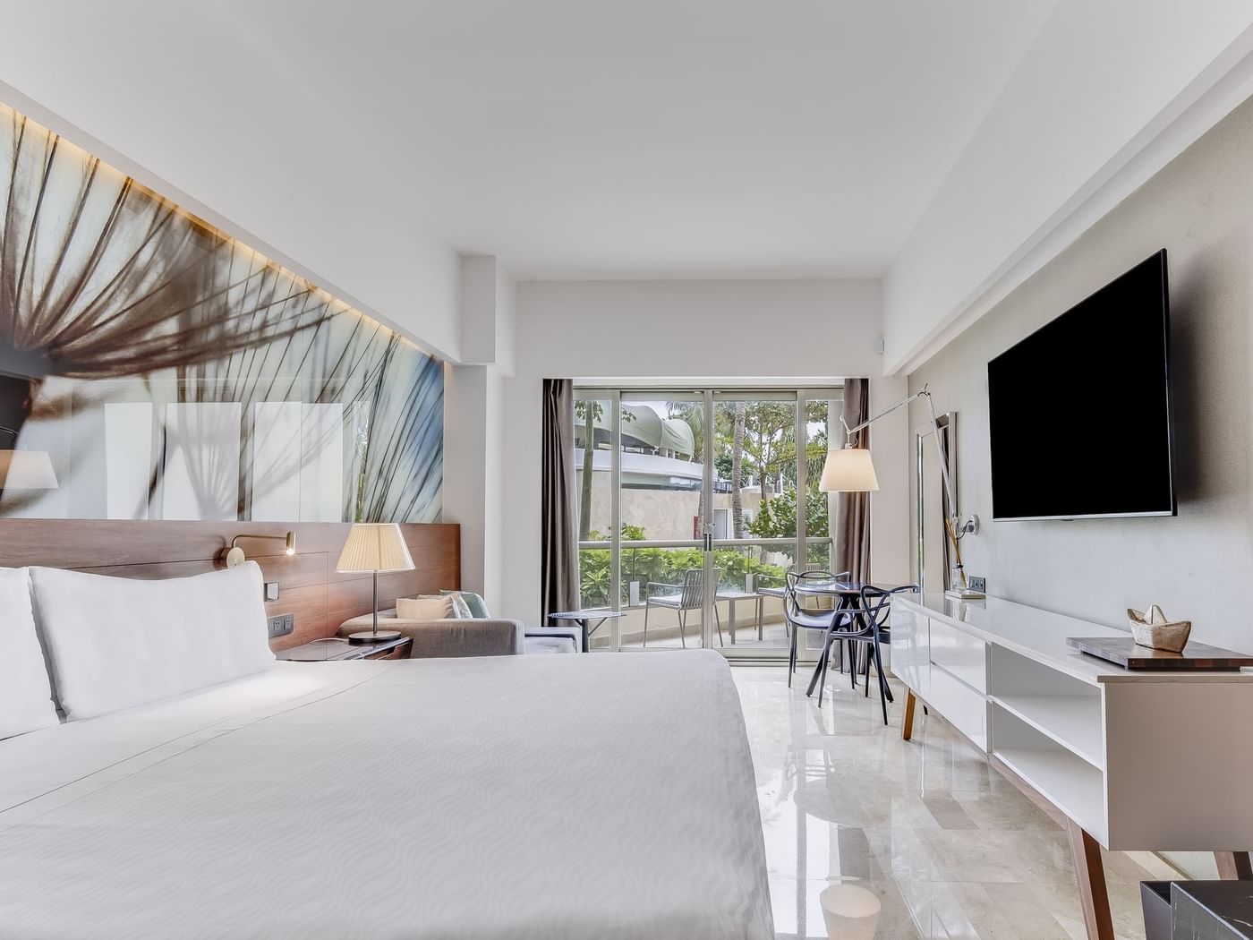 King bed and TV with work area in Premium Garden View room at Live Aqua Punta Cana