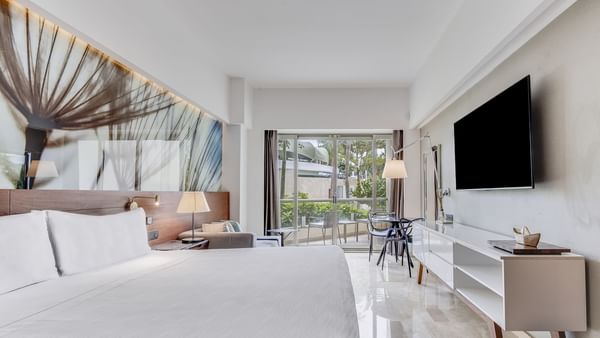 King bed and TV with work area in Premium Garden View room at Live Aqua Punta Cana