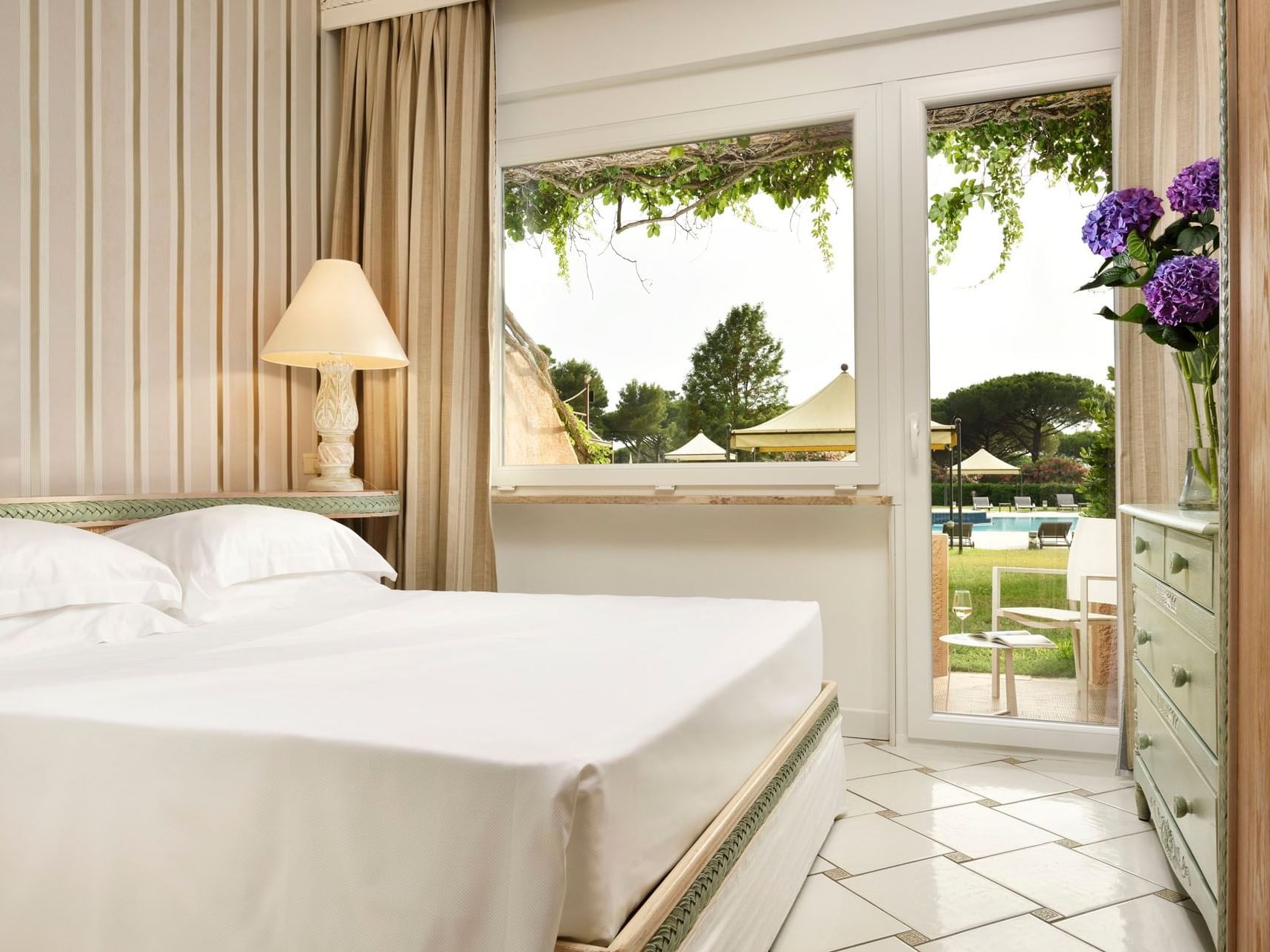 Bed in Classic Room with pool view at Golf Hotel Punta Ala
