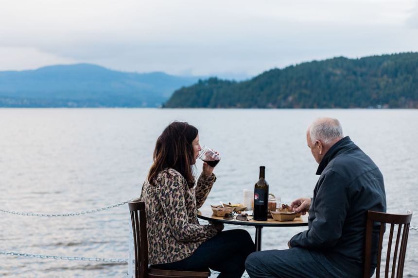 An old couple enjoying a meal by the Canal at Alderbrook Resort