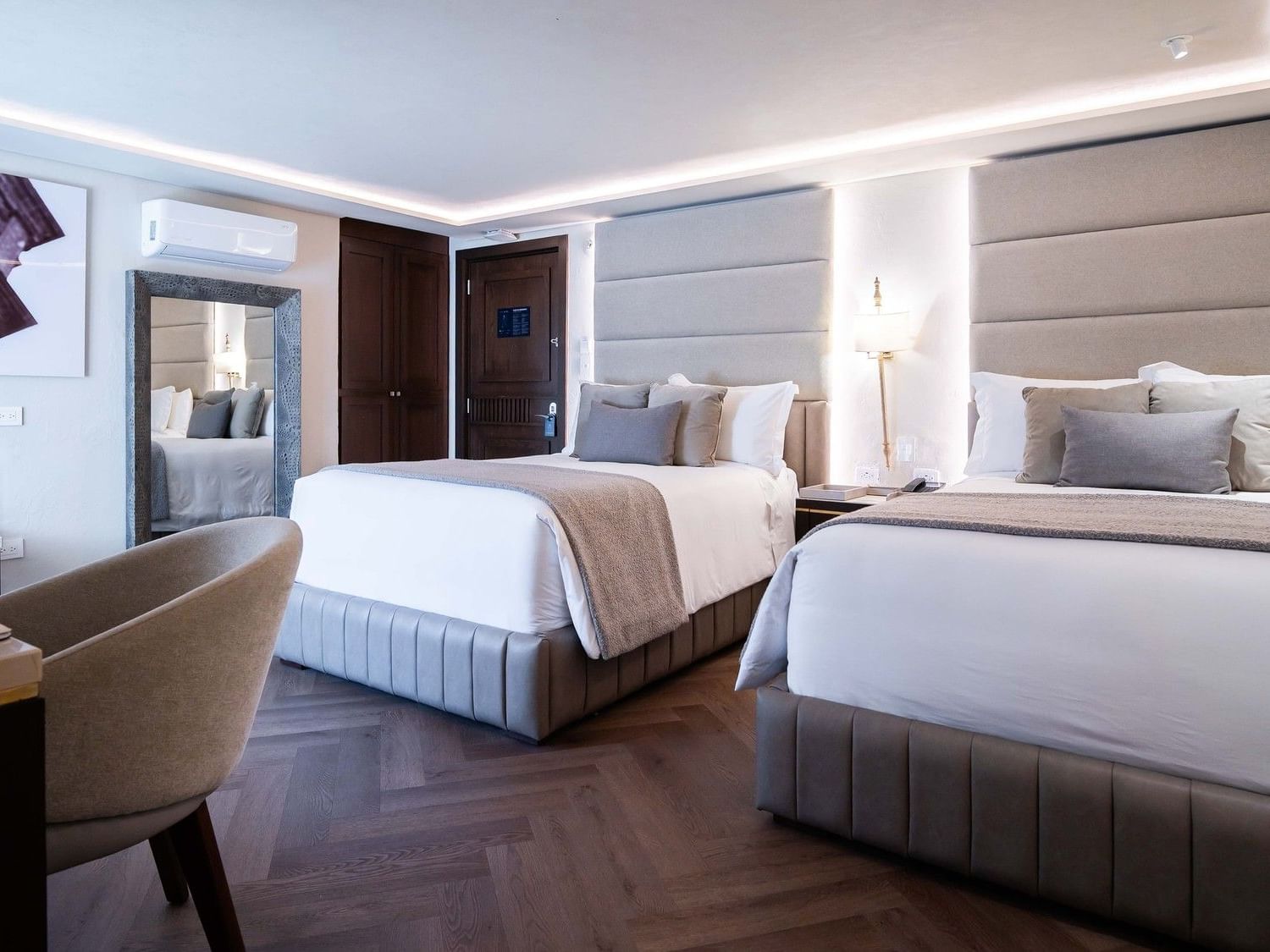 Two elegant beds with white linens and soft pillows in a luxury room at Quinta Real Puebla in Heroica Puebla de Zaragoza.