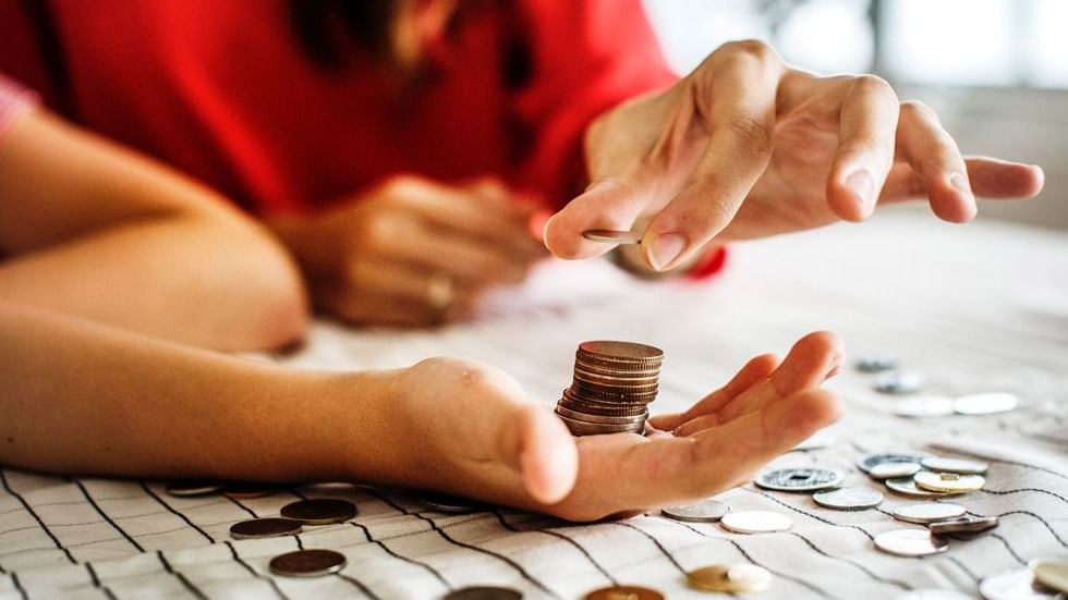 A person stacking coins on another person's hand at Sunway Hotel Seberang Jaya