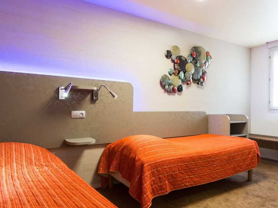 Interior of standard twin bedroom at Archotel