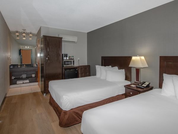 Two double beds in a hotel room.