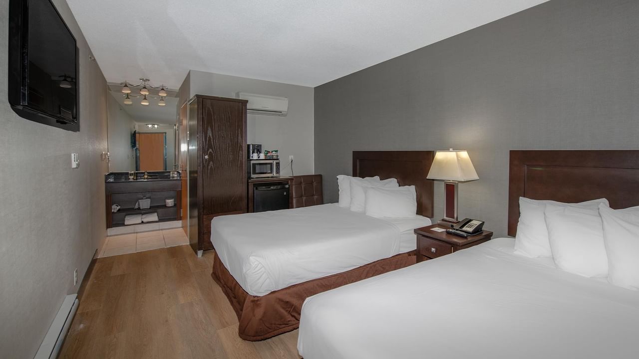 Two double beds in a hotel room.