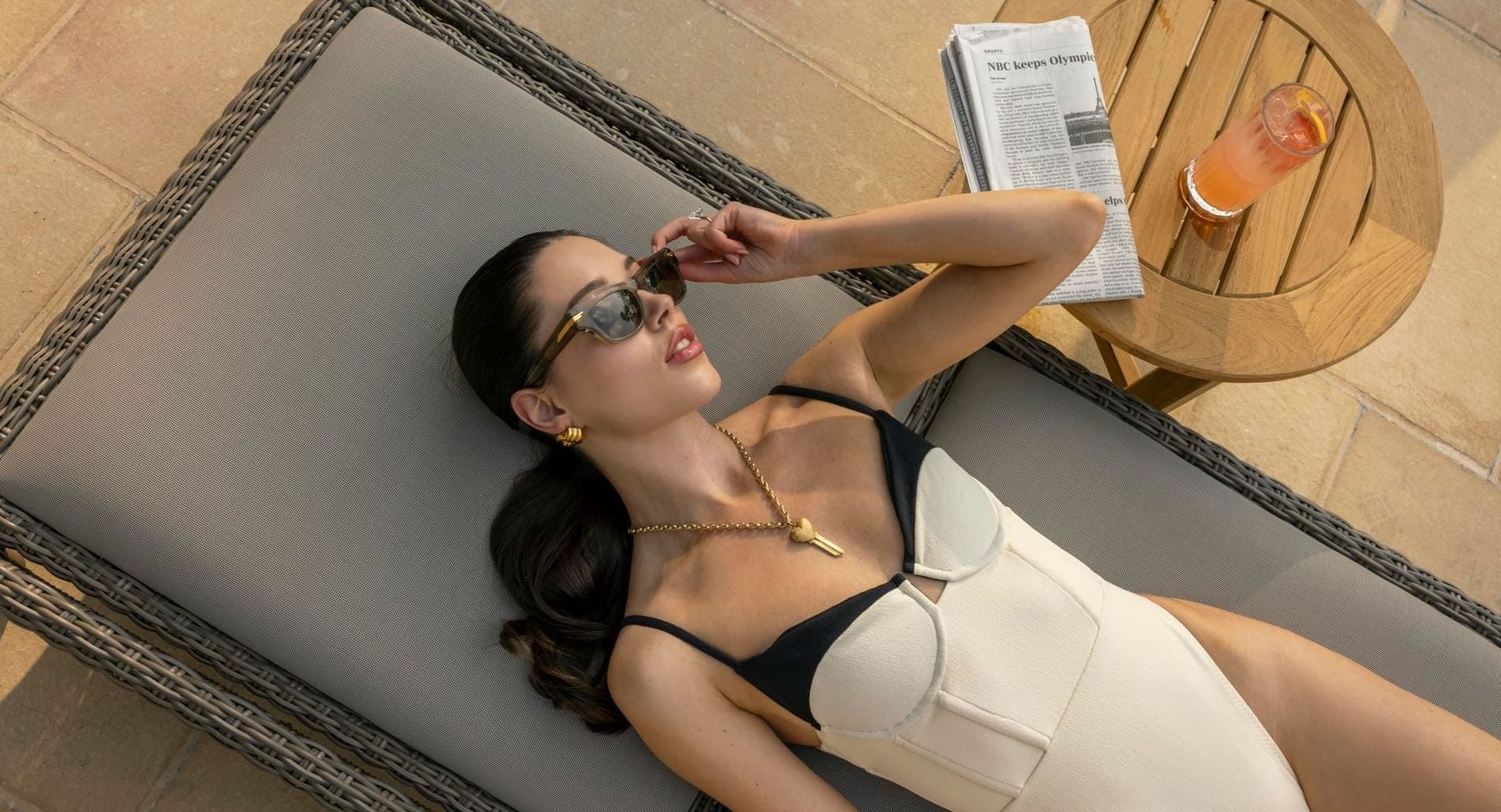 Woman relaxing on a sun lounger at Granduca Houston, one of the best Houston luxury hotels